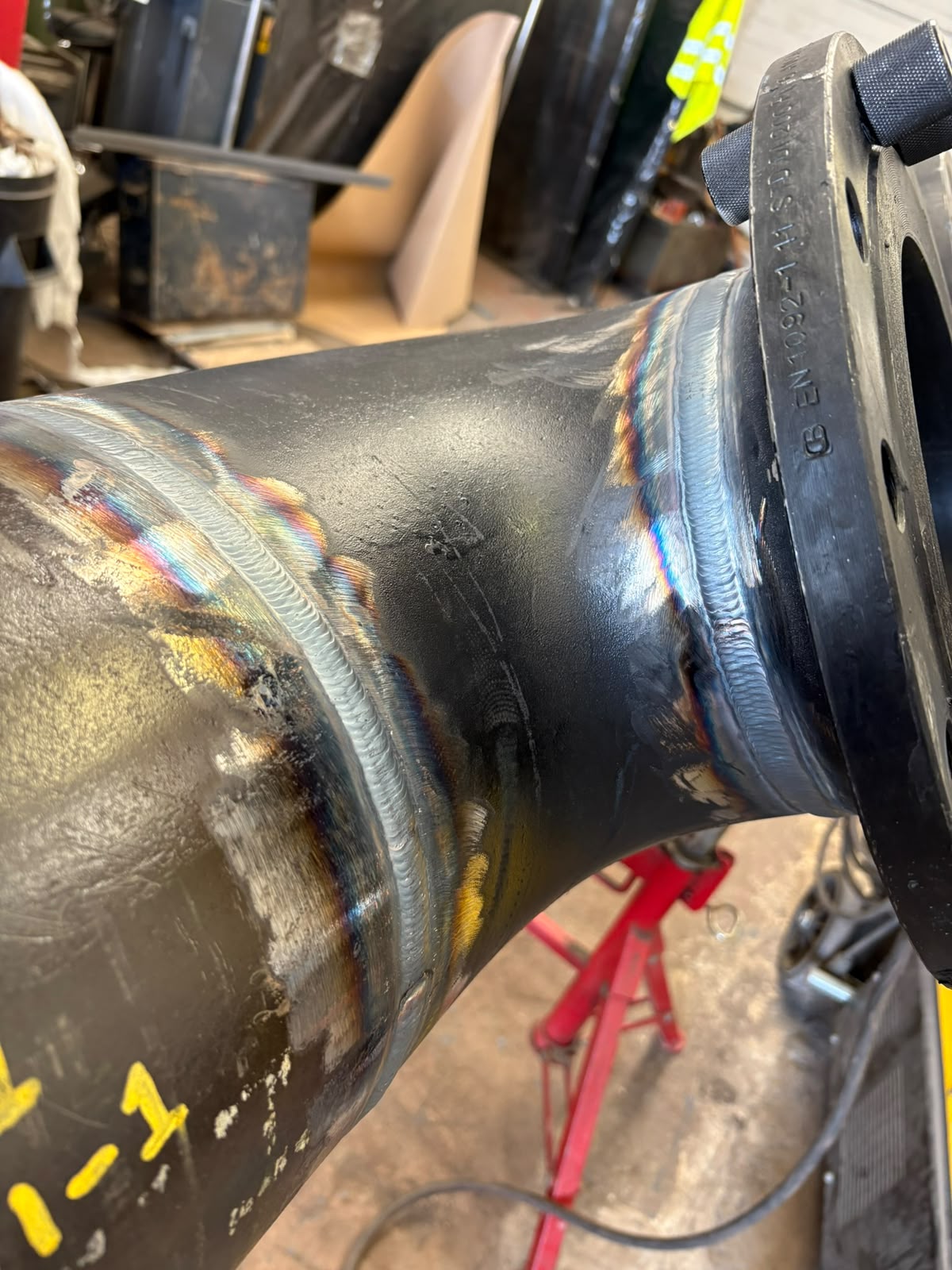 Welded carbon-steel pipe elbow with completed weld beads